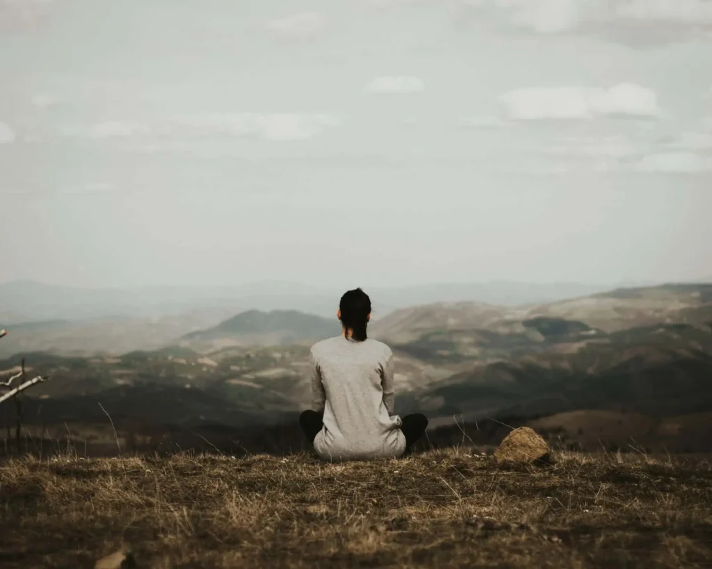 woman sitting in the mountain and healing from emotionally immature parents