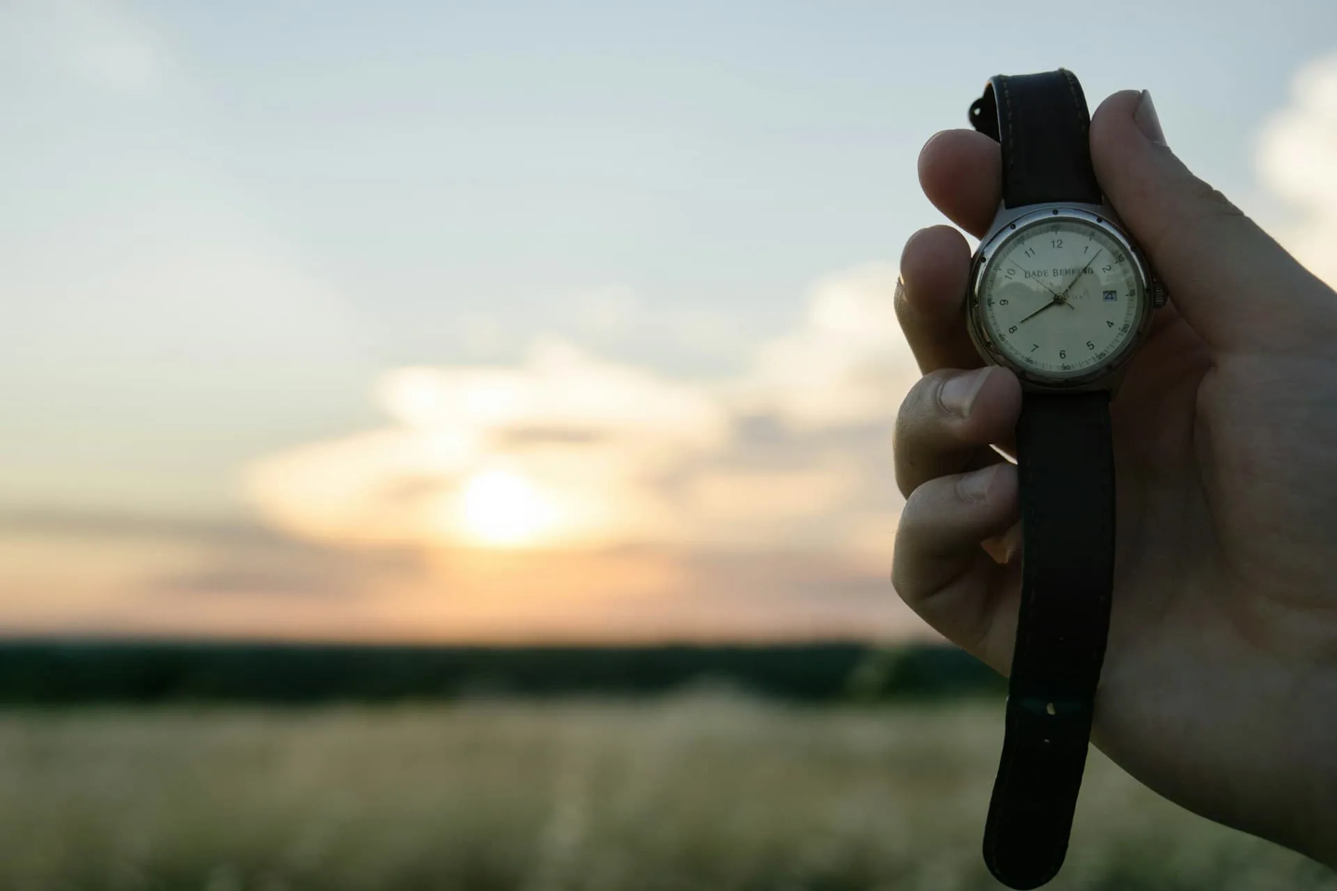 holding a watch on the beach
