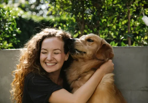 Happy Woman Hugging Golden Retriever