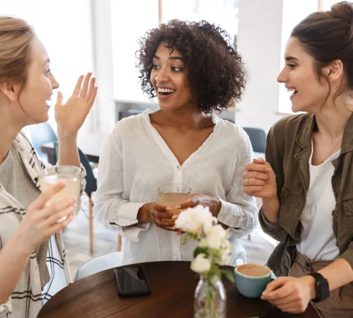 Three Women Socializing with Drinks