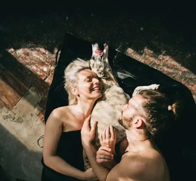 couple hugging a dog