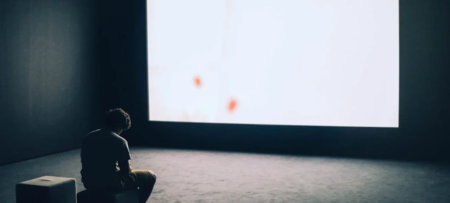 teenage boy alone in a dark room with open window