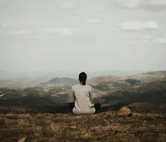woman sitting in the mountain and healing from anxiety